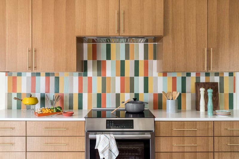 vibrant kitchen featuring a colorful striped backsplash that adds a lively touch to the space. | Copper Sky Design + Remodel