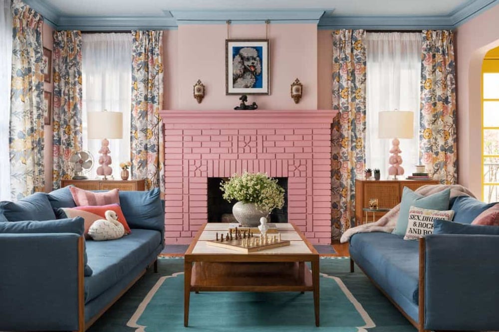 Pink fireplace and blue couches  | Copper Sky Design + Remodel